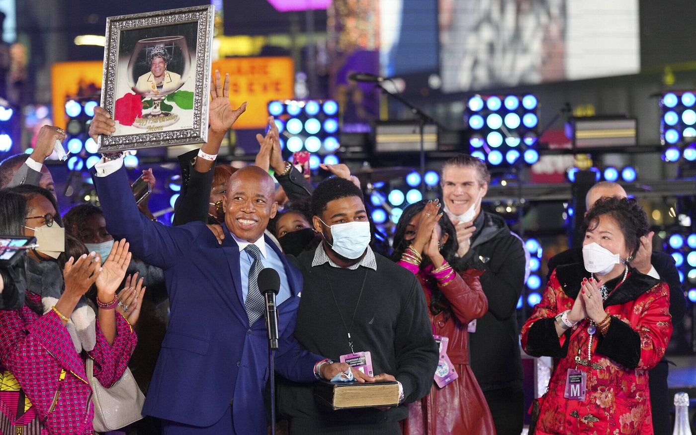 New York City Mayor Eric Adams holds a framed photograph of his late mother Dorothy above his head at his swearing-in ceremony in Times Square, January 1, 2022.